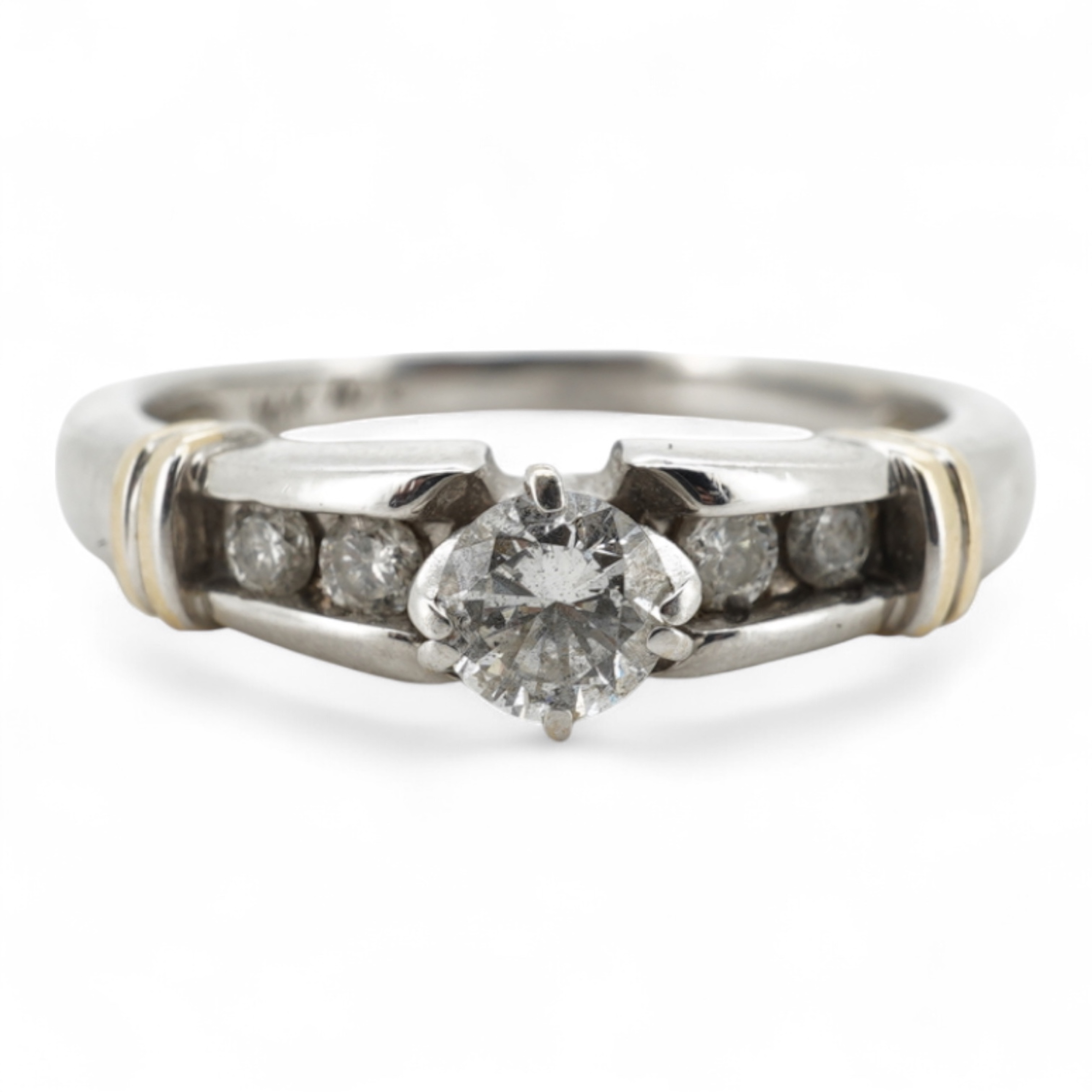 A diamond half-hoop ring, mid 19th century, pavé-set to the front with three rows of cushion-shaped diamonds totalling approximately 0.80 carats, to foliate carved shoulders, mounted in gold, size O, gross weight approxi